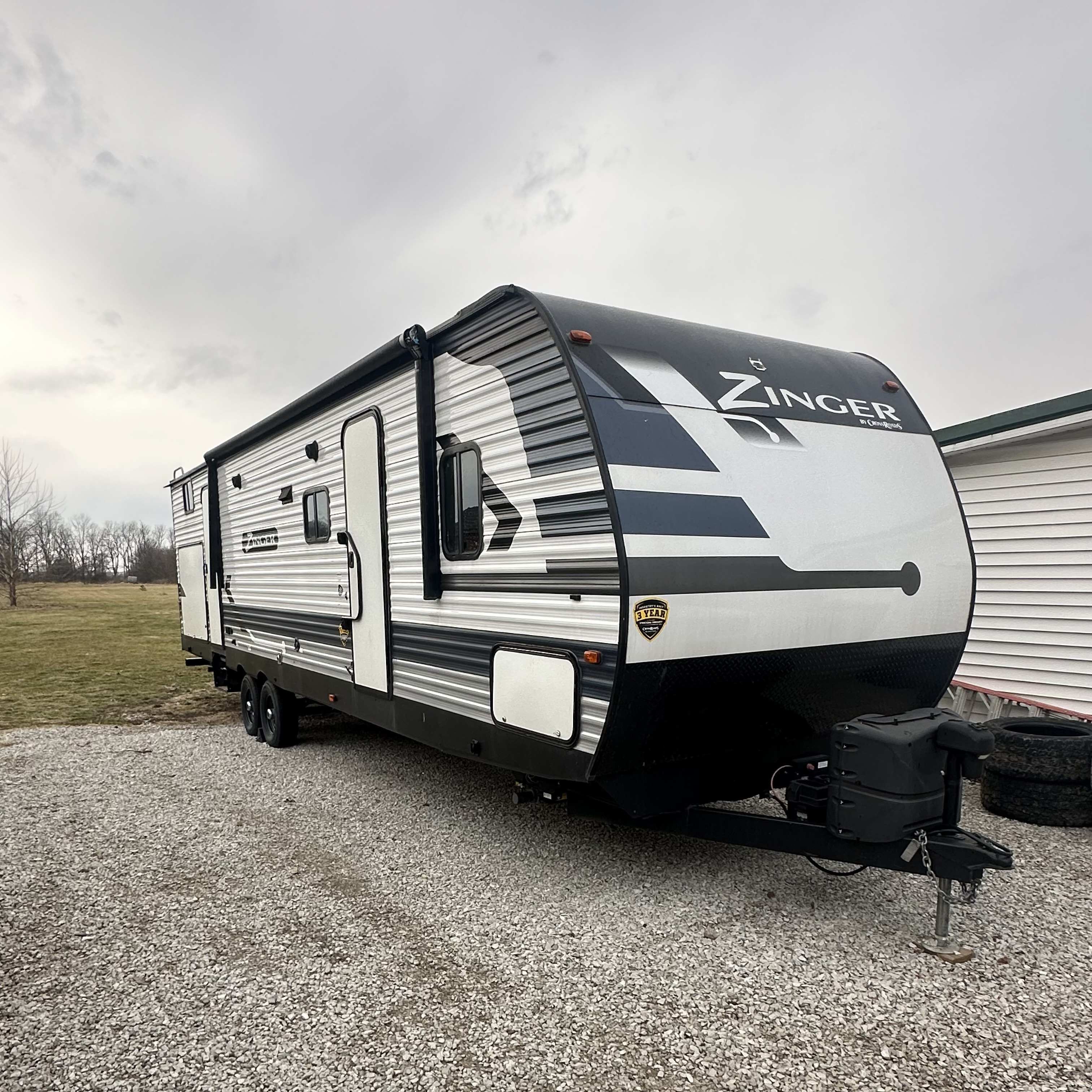 32-foot Crossroads Zinger travel trailer camper for rent in Crawfordsville, IN - sleeps 6-8 with full kitchen, bathroom, and entertainment center